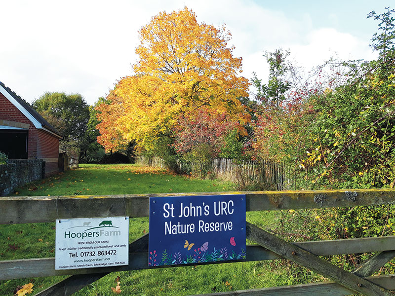 Gatepost with a sign that says 'St John's URC Nature Reserve'