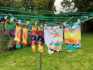 Tie-dyed clothes hanging on a washing line