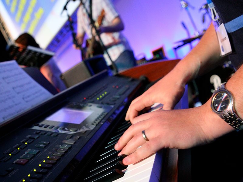 Hands playing an electric keyboard